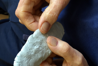 Image shown: 'Pat' working with clay