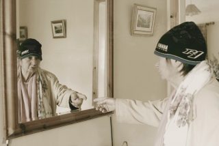 Image shown: E.gress film still. Rita looking in the mirror. By Marie Brett and Kevin O'Shanahan.