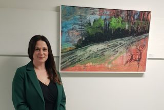 Image shown: Gardenland. Artist Fiona Cawley pictured with her artwork Displaced (acrylic & oil on board).