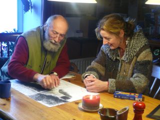 Image shown: Hearth artist working with a participant in his home