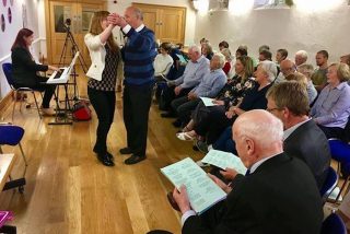 Sadhbh O’Sullivan dancing with a member of Past Times Community Choir during a collaborative event with Voices of Spring at McAuley Place in Naas